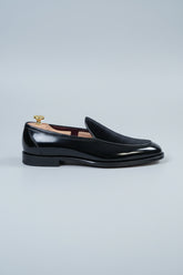 Black velvet slip-on tuxedo shoes with polished leather accents for formal events.